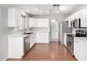 Modern kitchen with stainless steel appliances, white cabinets, quartz countertops, and hardwood floors at 11455 E Persimmon Ave, Mesa, AZ 85212