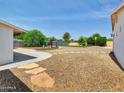Expansive backyard featuring gravel, grass turf, a pergola, and mature trees, perfect for outdoor activities at 12210 N 67Th St, Scottsdale, AZ 85254