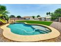 Backyard oasis with refreshing pool, green turf and shaded pergola; ideal for outdoor enjoyment at 12210 N 67Th St, Scottsdale, AZ 85254