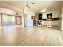 Open kitchen with modern white cabinets, stainless steel appliances, and wood floors at 1309 W 10Th St, Tempe, AZ 85281