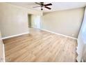 Bright living room featuring wood floors, neutral walls, ceiling fan, and ample natural light from large windows at 1309 W 10Th St, Tempe, AZ 85281