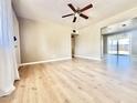Bright living room featuring wood floors, neutral walls, ceiling fan, and view to the backyard at 1309 W 10Th St, Tempe, AZ 85281