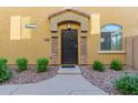 Inviting entryway with stone accents leading to a secure, stylish front door at 1350 S Greenfield Rd # 1040, Mesa, AZ 85206