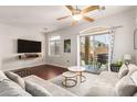 Bright living room featuring a ceiling fan and sliding glass doors to the patio at 1350 S Greenfield Rd # 1040, Mesa, AZ 85206