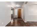 Inviting entryway with neutral walls, tiled floor, and ample natural light, leading to the rest of the home at 14440 W Cholla St, Surprise, AZ 85379