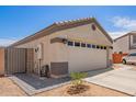 Single story home with a two car garage, desert landscaping, and a driveway with paved walkway at 14809 N El Frio Cir, El Mirage, AZ 85335