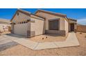 Single story home with a two car garage, desert landscaping, and a driveway with paved walkway at 14809 N El Frio Cir, El Mirage, AZ 85335