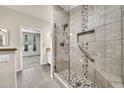 Bathroom features a tiled shower with glass door, mosaic details, and grab bar at 15151 N Frank Lloyd Wright Blvd # 1088, Scottsdale, AZ 85260