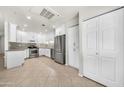 Modern kitchen featuring white cabinets, stainless steel appliances and tile backsplash at 15151 N Frank Lloyd Wright Blvd # 1088, Scottsdale, AZ 85260