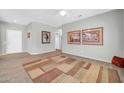 Spacious living room with wood flooring, neutral walls, and decorative artwork at 15161 W Cactus Ridge Way, Surprise, AZ 85374