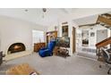 Relaxing living room with cozy chair and adjacent staircase at 16276 E Rosetta Dr # 58, Fountain Hills, AZ 85268