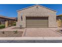 Exterior shot of the garage showcasing a tan stucco finish and brick paver driveway at 1824 N Red Clf, Mesa, AZ 85207