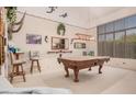 Spacious game room featuring a pool table, ample lighting, and a view to the backyard at 1902 S Rialto -- # Mesa, Mesa, AZ 85209