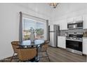 Eat-in kitchen featuring stainless steel appliances, bright white cabinets, and modern finishes at 19601 N 7Th St # 2095, Phoenix, AZ 85024