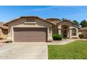 Inviting single-Gathering home with a manicured lawn and a spacious two-car garage at 2244 E Rawhide St, Gilbert, AZ 85296