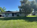 Well-maintained single-level home with an expansive front lawn and mature landscaping at 2350 E Melrose St, Gilbert, AZ 85297
