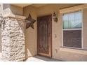 Intricate iron gate front door with stone pillar accent and decorative star at 26062 W Potter Dr, Buckeye, AZ 85396