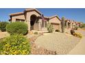 Charming single-story home showcasing desert landscaping and a welcoming front entrance at 26624 N 41St St, Cave Creek, AZ 85331