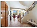 Grand entryway with staircase, tile flooring, and view into the bright and spacious living areas at 28990 N White Feather Ln # 185, Scottsdale, AZ 85262
