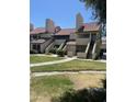 Attractive condo building featuring private entries, well-maintained landscaping, and red tile roofing at 30 E Brown Rd # 2065, Mesa, AZ 85201