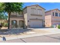 Charming two-story home featuring a neutral color palette and a well-manicured front yard at 30032 N Desert Willow Blvd, San Tan Valley, AZ 85143