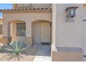 Inviting front porch with decorative door and desert landscaping, featuring address number at 30032 N Desert Willow Blvd, San Tan Valley, AZ 85143