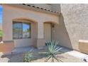Inviting front porch with decorative door and desert landscaping framing the entrance at 30032 N Desert Willow Blvd, San Tan Valley, AZ 85143