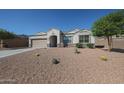 Attractive single-story home with a two-car garage and a low-water desert rock front yard at 30560 W Weldon Ave, Buckeye, AZ 85396