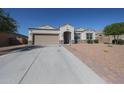 Beautiful single-story house featuring a well-maintained driveway and desert landscaping at 30560 W Weldon Ave, Buckeye, AZ 85396