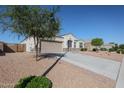 Inviting one-story home showcasing a two-car garage and desert-style landscaping for easy care at 30560 W Weldon Ave, Buckeye, AZ 85396