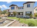 Beautiful backyard showcasing artificial grass, desert landscaping, and a charming stone fountain at 31156 N 137Th Ln, Peoria, AZ 85383