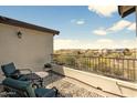 Private balcony with seating, offering serene views of the surrounding neighborhood at 31156 N 137Th Ln, Peoria, AZ 85383