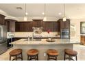 Gourmet kitchen features stainless appliances, granite counters, and a large island at 31156 N 137Th Ln, Peoria, AZ 85383