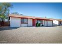 Single-story home featuring low-maintenance landscaping, a gravel yard, and a two-car garage at 3209 W Charleston Ave, Phoenix, AZ 85053