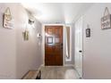 Charming foyer featuring a stained wood front door, tile flooring and decorative wall hangings at 3345 E University Dr # 72, Mesa, AZ 85213