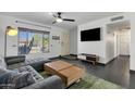 Bright living area showcasing a comfortable sofa, modern TV setup, and large window for natural light at 3711 S Judd St, Tempe, AZ 85282