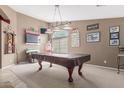 This game room features a pool table, TV and an array of artwork at 3784 E Simpson Ct, Gilbert, AZ 85297