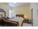 Cozy bedroom features neutral walls, plush carpeting, and a large window at 43302 W Bunker Dr, Maricopa, AZ 85138