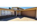 Close up of the exterior of the home including the front door, flower bed, and two car garage at 4517 S Grandview Ave, Tempe, AZ 85282