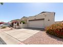 Attached two-car garage and driveway, with beautiful desert landscaping enhancing curb appeal at 630 E Jensen St # 116, Mesa, AZ 85203