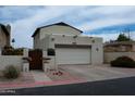 Charming stucco home featuring a garage, gated front yard, and low-maintenance desert landscaping at 630 E Jensen St # 116, Mesa, AZ 85203
