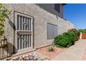 Exterior front door with security screen, landscaping, and a welcoming welcome mat at 630 E Jensen St # 116, Mesa, AZ 85203