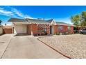 Cozy brick house with a covered parking area and a tidy gravel front yard, complete with a charming white front door at 6312 N 41St Ave, Phoenix, AZ 85019