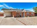 Cozy brick house with a covered parking area and a tidy gravel front yard, complete with a charming white front door at 6312 N 41St Ave, Phoenix, AZ 85019