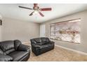 Inviting living room featuring neutral paint, ceiling fan, tile flooring, and comfortable seating with a nice view at 6312 N 41St Ave, Phoenix, AZ 85019