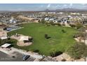 Great aerial view of the neighborhood park with playground, green space, and walking paths for community enjoyment at 6462 E Raftriver St, Mesa, AZ 85215