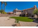 Spacious backyard with desert landscaping, a patio, and a lush artificial lawn at 6462 E Raftriver St, Mesa, AZ 85215