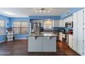 Bright kitchen featuring white cabinets, stainless steel appliances, and an island at 6462 E Raftriver St, Mesa, AZ 85215