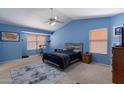 Spacious main bedroom features vaulted ceilings, carpeted floors, and large windows at 6462 E Raftriver St, Mesa, AZ 85215