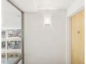 Bright hallway with modern lighting and views of the building exterior at 7151 E Rancho Vista Dr # 3001, Scottsdale, AZ 85251